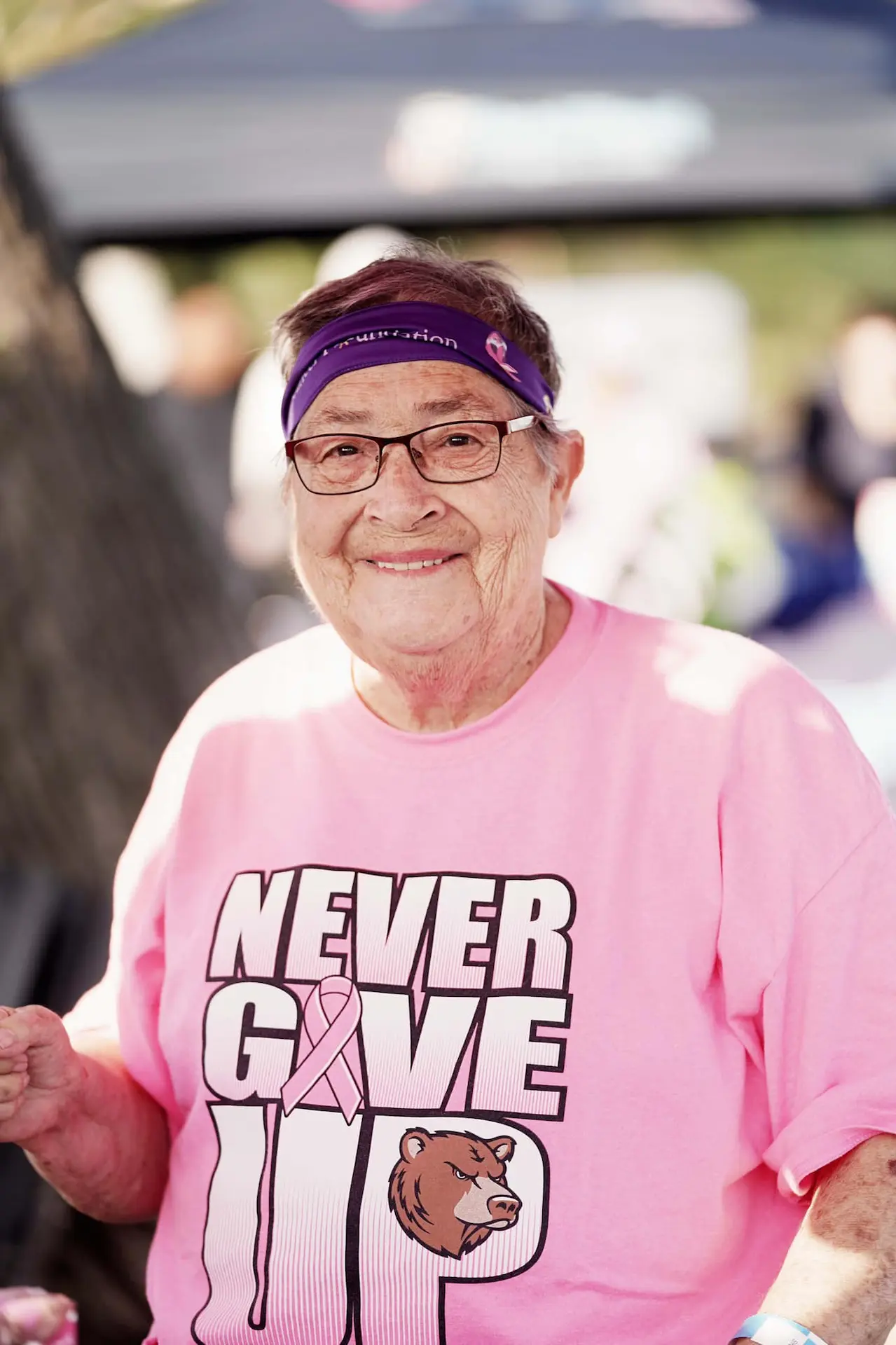 An older woman wearing a never give up shirt at Kern Run Walk
