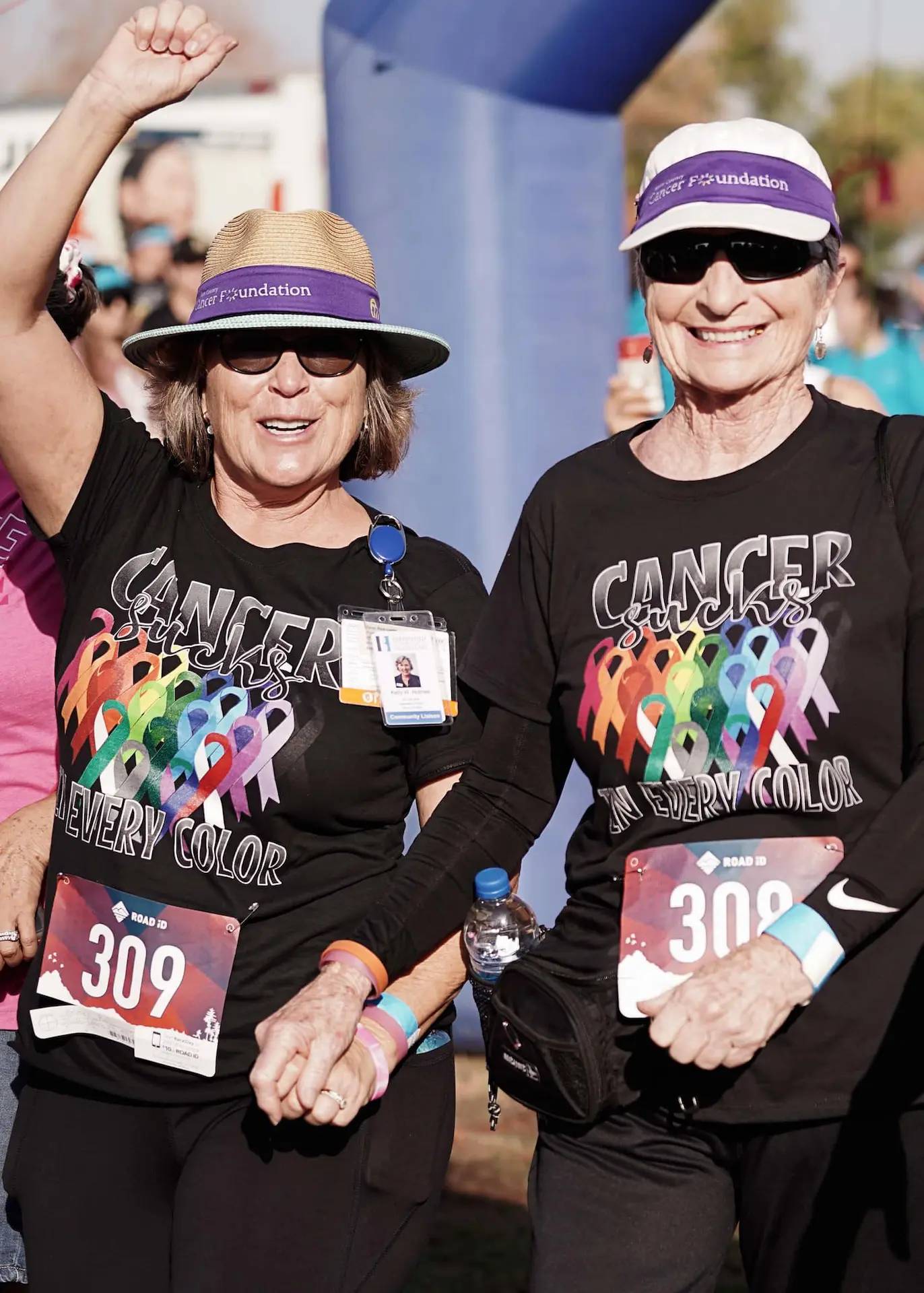 Two women hold hands as they participate in the Kern Run Walk