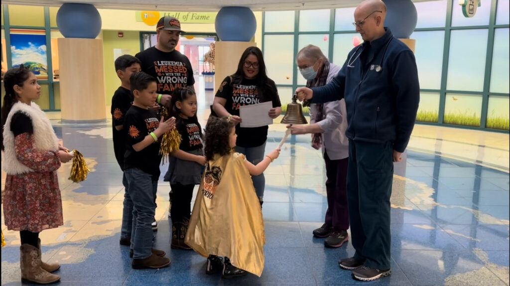 Madelyn Martinez rings the bell after finishing leukemia treatment